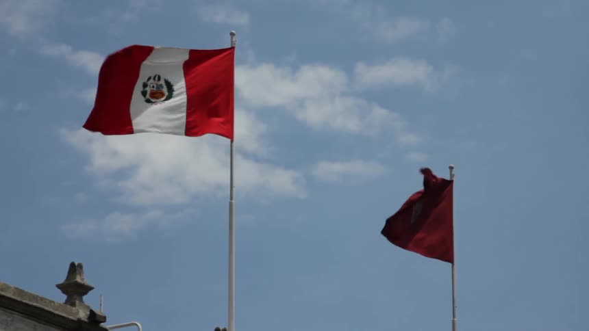 Flags are blowing in the air above a building