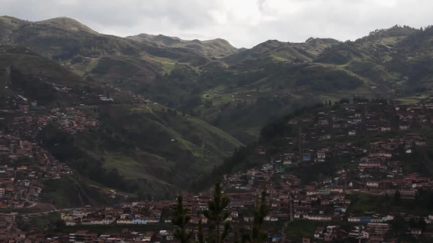 View of a town that sits on hills by a mountain range