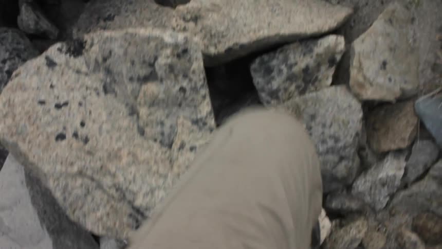 A person is walking over rocks
