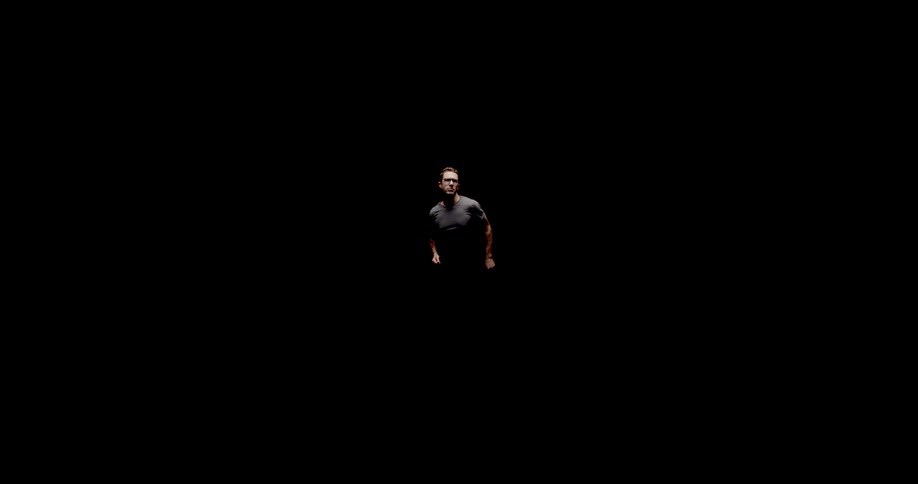 A man running with darkness in the background