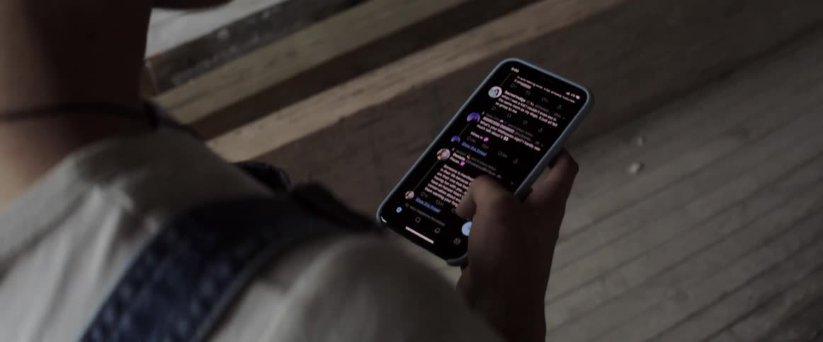 A teenager scrolls through their phone