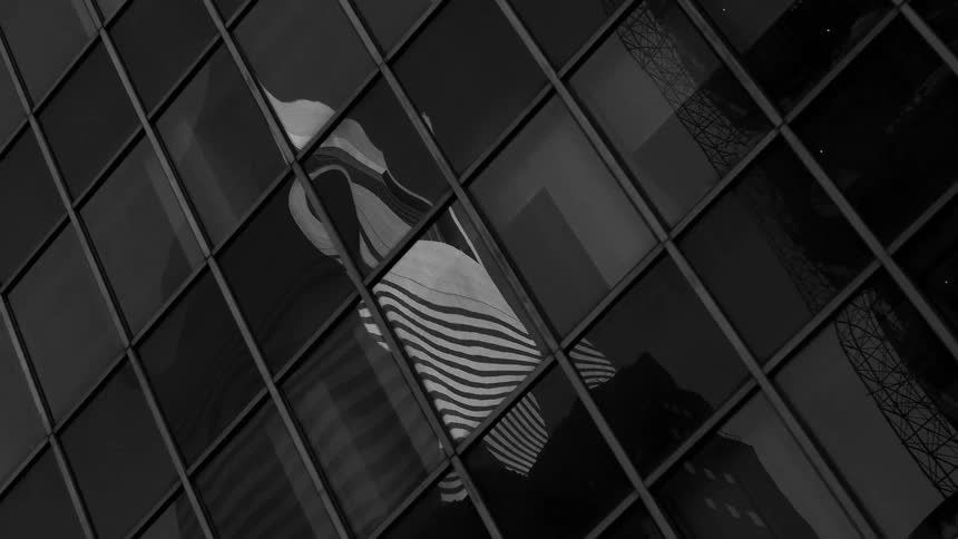 A reflection of an office building on another building
