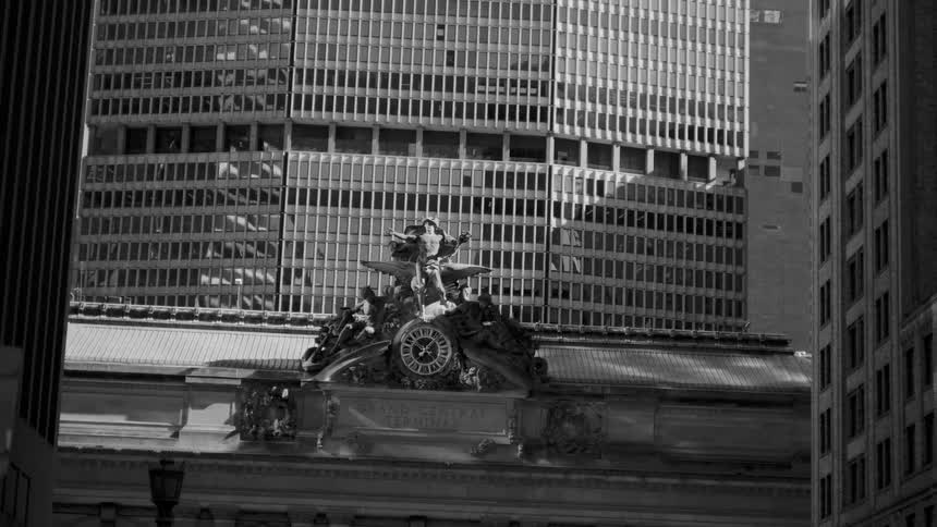 A decorative facade of a train station in an urban area