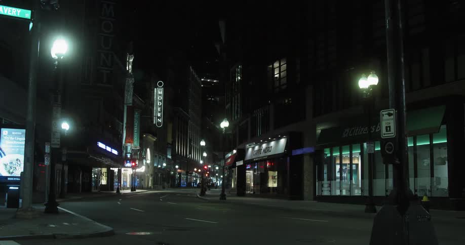 Closed businesses on a city street at night