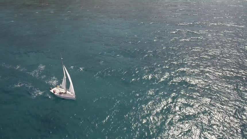 Aerial view of a sailboat traveling on the ocean
