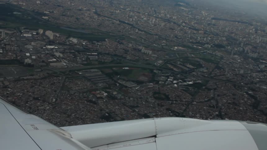 A plane flying over a dense city