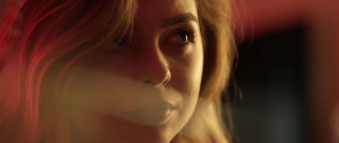 A young woman raises her eyes and looks up