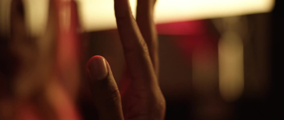 A person rotates their hand and touches a surface