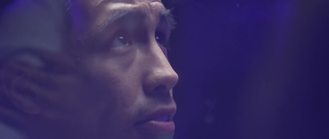 A man watches a person through glass