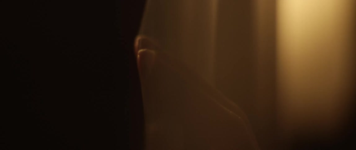 Two hands touch through a plastic sheet