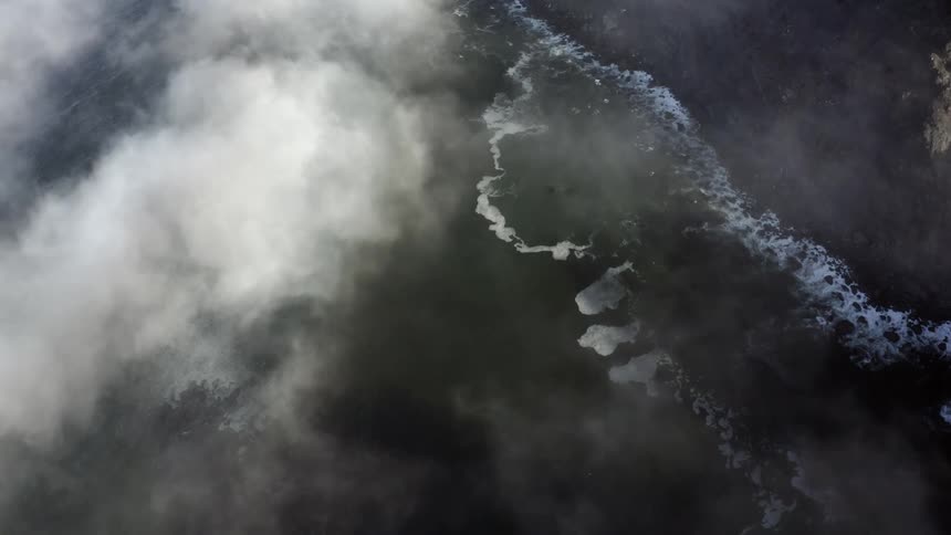 Birds eye view of waves rolling to the shore
