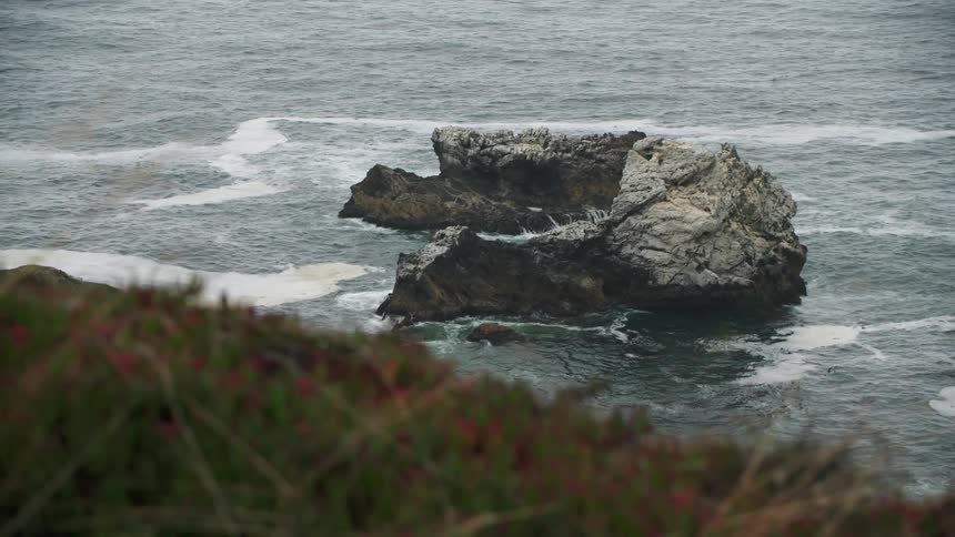 Small rocky island in front of beach