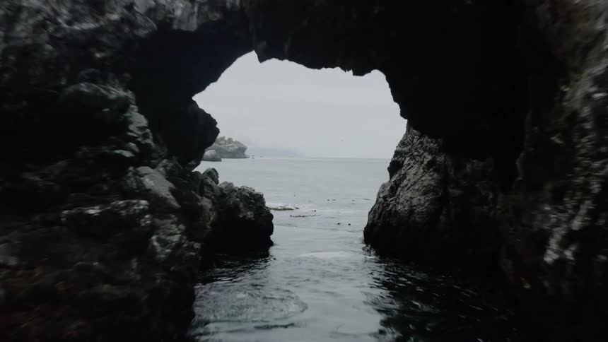The ocean off a rocky coastline on a cloudy day