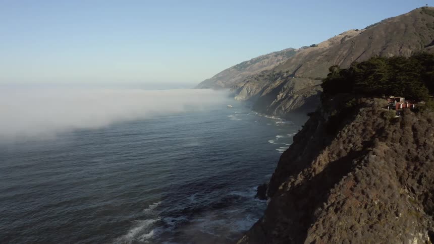 Aerial view of mountain ranges and cliffs next to the ocean