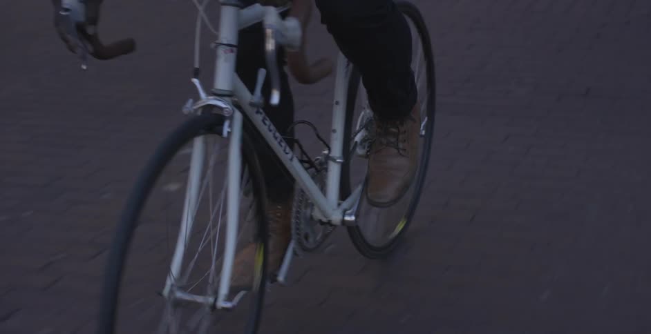 A man is riding a bike down a street