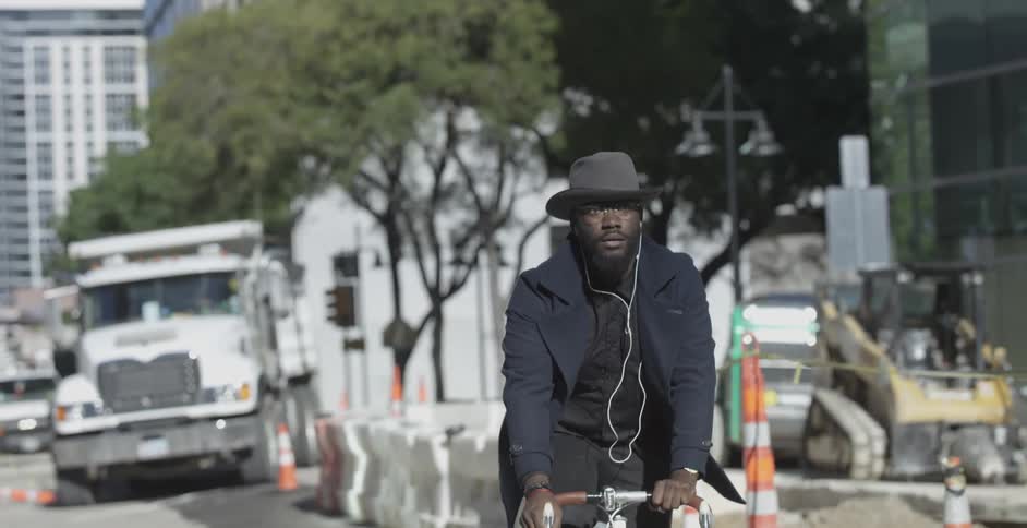 A man is riding a bike down a city street
