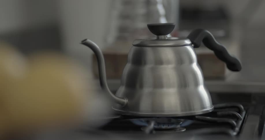 A tea kettle sits on a stove