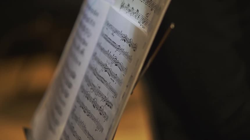 Sheet music sits on a stand