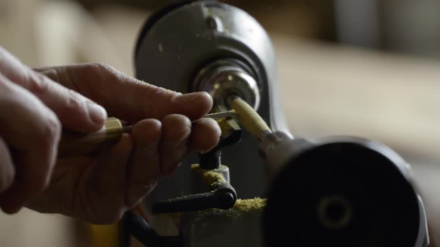 A person is using a machine on tools