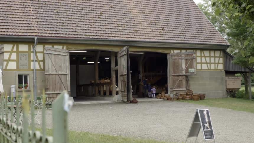 Woman and kids stand in the farmhouse