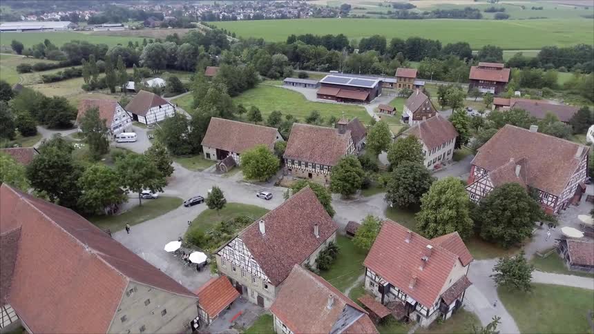 Aerial view of small town surrounded by grass fields