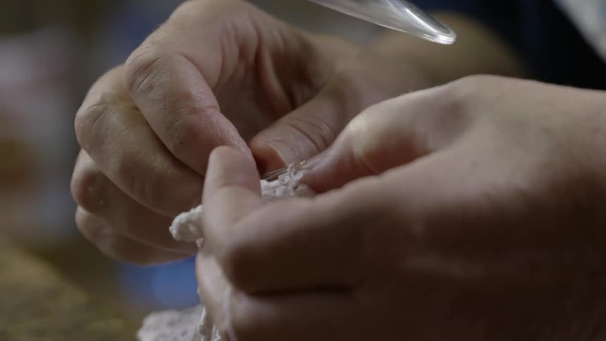 A person is holding yarn