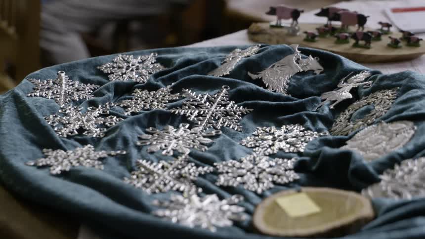 Silver necklaces on the tray covered with a blue cloth