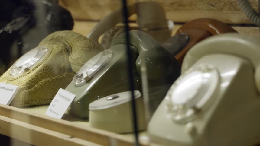 Vintage rotary phones in a showcase