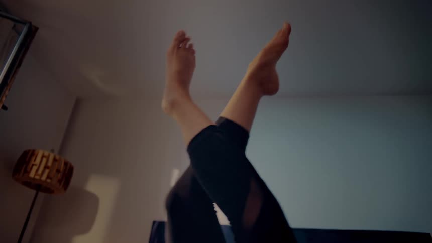 A woman is moving her legs in the air