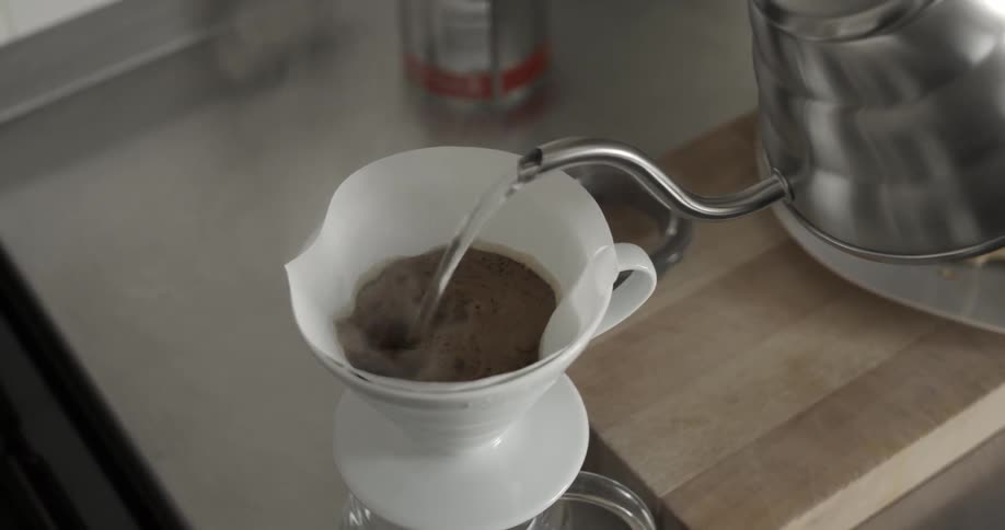 Hot water is poured over coffee grounds and filter