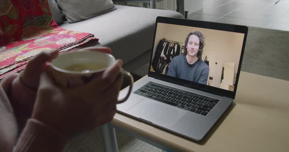 A woman chats to a man on a video call