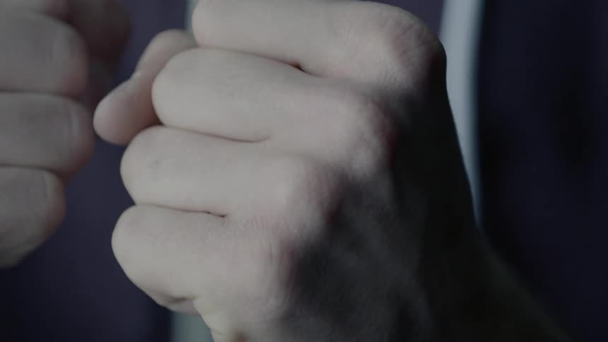 A person clenches her fists
