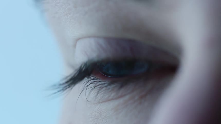 Persons eye blinks as the person does not move