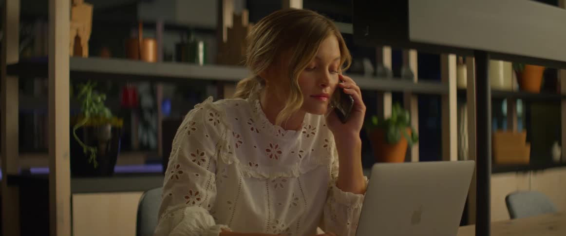 A woman becoming upset after answering a phone
