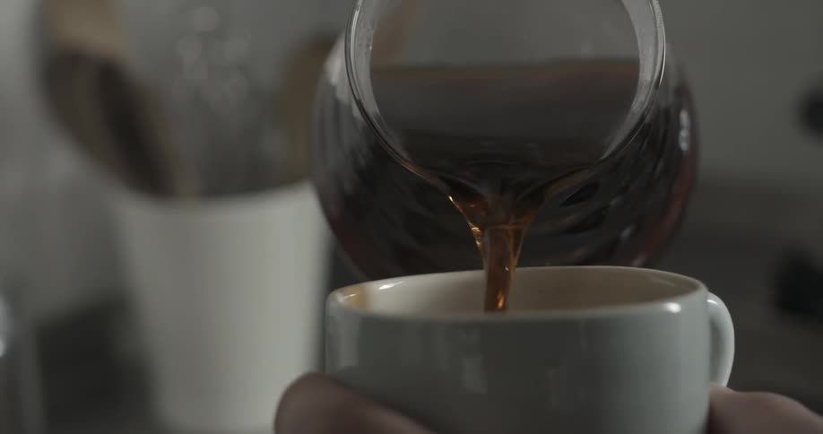 A person fills a mug from a pitcher