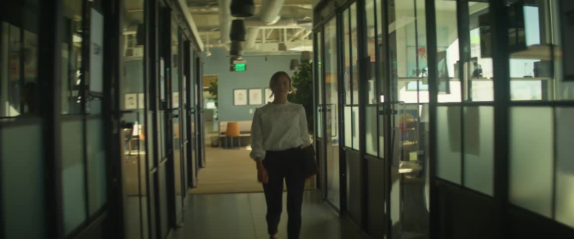 A female employee walks down an office hallway