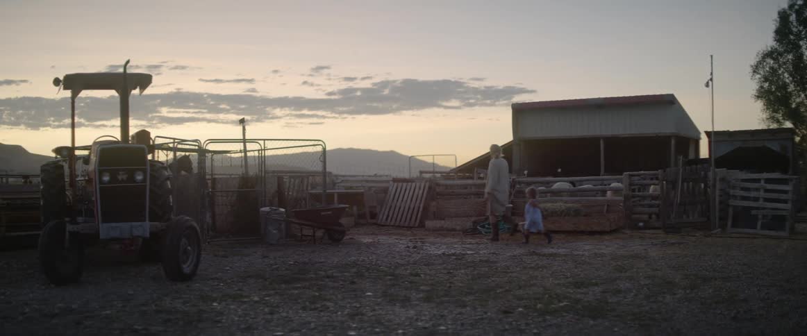 Mother and daughter walks in the farm at dusk