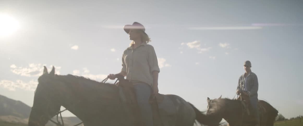 People are riding horses outdoors
