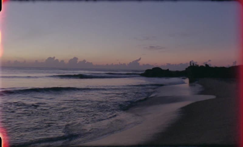 The tide comes in at the beach during dusk