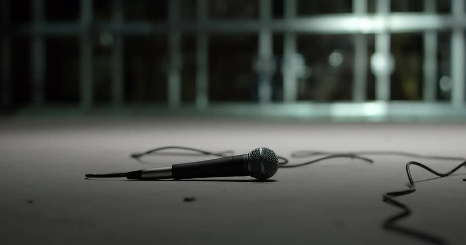 A man walks over a microphone on the ground