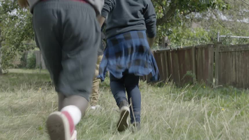 Black children run happily in the yard