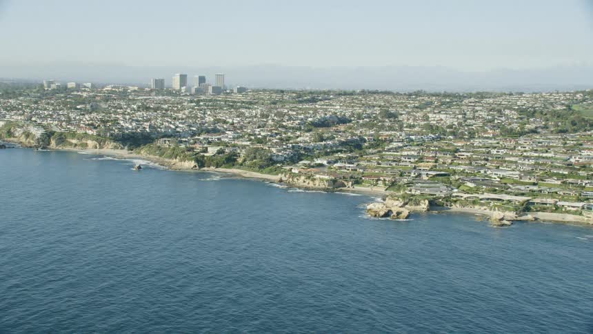 The water and shore in front of a city skyline