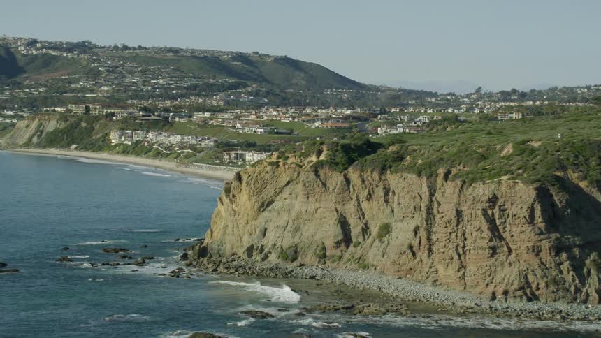 Waves crash against rocky cliffs