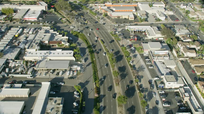 A highway with vehicles trees and buildings