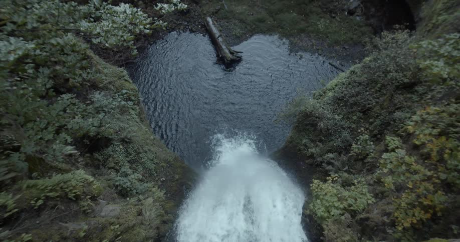 A waterfall flowing in to a river below