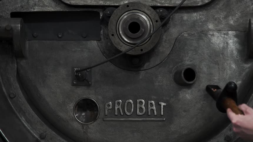 A person checks parts of machinery