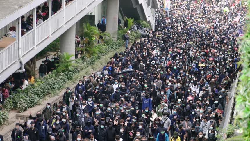 Large crowd of protesters wearing face masks marching during black live matters movement