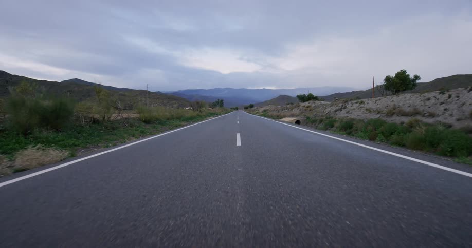 A road sprawls through a mountainous area