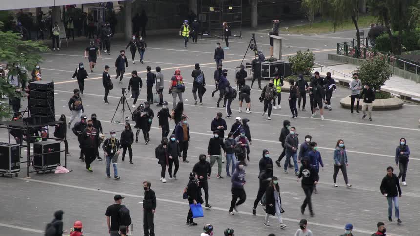 Crowd of people walk and run on the street