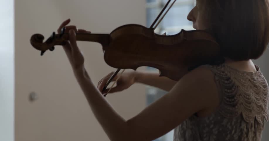 A woman is playing a violin
